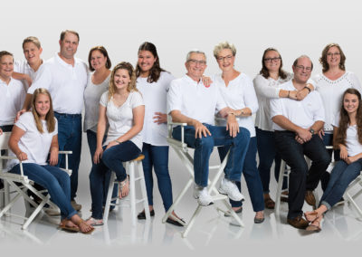 Family portrait of 13 on white background