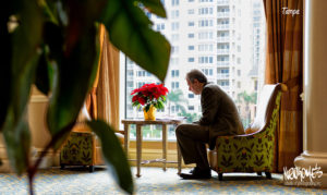 man in lobby using laptop